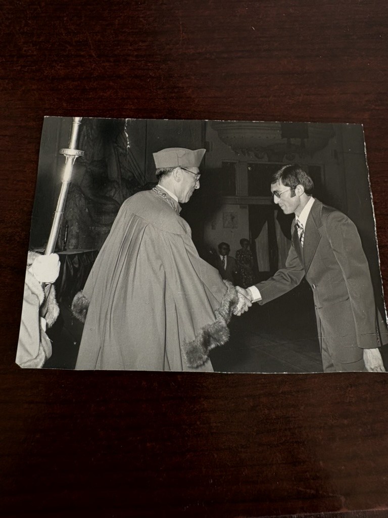 Younus Samadzada greeting an academic official at a formal ceremony