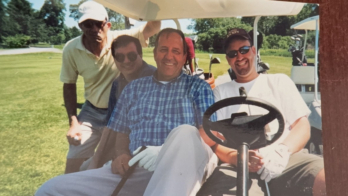 Younus Samadzada and friends gathered around a golf cart